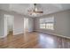 Bedroom featuring hardwood flooring, tray ceiling and lots of natural light at 647 New England Way, Lawrenceville, GA 30046