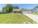 Charming single-story home with a well-manicured lawn and attached two-car garage on a sunny day at 647 New England Way, Lawrenceville, GA 30046