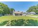 Inviting single-story house featuring a green lawn, blue siding, and a driveway leading to the garage at 647 New England Way, Lawrenceville, GA 30046
