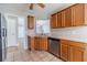 Close-up of kitchen featuring stainless steel appliances, wooden cabinets, and a pass-through window to another room at 647 New England Way, Lawrenceville, GA 30046