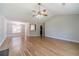 Open living area with vaulted ceilings, wood floors, and a view of the dining area and kitchen at 647 New England Way, Lawrenceville, GA 30046