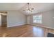 Inviting living room featuring wood floors, fireplace, vaulted ceilings, and ample natural light from a window at 647 New England Way, Lawrenceville, GA 30046