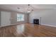 Bright living room with wood floors, a fireplace, vaulted ceilings, and natural light from windows and front door at 647 New England Way, Lawrenceville, GA 30046
