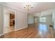 Spacious open floor plan with wood floors, connecting the dining area, living room, and kitchen for easy flow at 647 New England Way, Lawrenceville, GA 30046