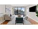 Bright living room features city views, modern decor, and a large window for natural light at 1280 W Peachtree Nw St # 3208, Atlanta, GA 30309