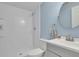 Cozy, updated bathroom featuring a walk-in shower, a blue painted wall, and modern fixtures at 793 Fairington Pl, Lawrenceville, GA 30044