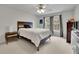 Bedroom features a contemporary wood-trimmed headboard, neutral walls, and carpet flooring at 793 Fairington Pl, Lawrenceville, GA 30044