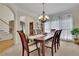 Formal dining room with a chandelier, large windows, and ample seating at 793 Fairington Pl, Lawrenceville, GA 30044