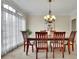 Well-lit dining room with a large window, chandelier, and elegant table setting at 793 Fairington Pl, Lawrenceville, GA 30044