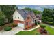 Side view of a brick house with a two-car garage, green lawn, and mature landscaping at 793 Fairington Pl, Lawrenceville, GA 30044