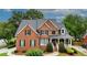 Charming two-story brick home with a well-maintained lawn and mature trees at 793 Fairington Pl, Lawrenceville, GA 30044