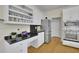 Kitchen includes granite countertops, stainless steel appliances, an eat-at bar, and custom white cabinetry at 793 Fairington Pl, Lawrenceville, GA 30044