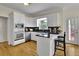 White cabinets with modern appliances, granite countertops, and eat-at bar located in the kitchen at 793 Fairington Pl, Lawrenceville, GA 30044
