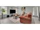 Living room featuring large windows for natural light, neutral walls, and comfortable furniture at 793 Fairington Pl, Lawrenceville, GA 30044