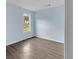 Bedroom with light blue walls, wood-look floors, and a single window at 1139 Mainstreet Valley Dr, Stone Mountain, GA 30088