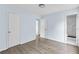 Bedroom with light blue walls and wood-look floors has an attached bathroom at 1139 Mainstreet Valley Dr, Stone Mountain, GA 30088