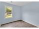 Bedroom with light blue walls and view of fenced back yard from the window at 1139 Mainstreet Valley Dr, Stone Mountain, GA 30088