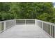 A white painted deck overlooks a tranquil backyard filled with trees, perfect for outdoor relaxation at 1139 Mainstreet Valley Dr, Stone Mountain, GA 30088
