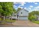 Charming light blue two-story home with a unique roofline, front porch, and well-maintained lawn at 1139 Mainstreet Valley Dr, Stone Mountain, GA 30088