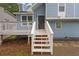 Close-up of the light blue home's front porch with white railings and steps leading to the entrance at 1139 Mainstreet Valley Dr, Stone Mountain, GA 30088