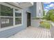 View of the front porch with a white railing, showcasing the entrance and side windows at 1139 Mainstreet Valley Dr, Stone Mountain, GA 30088
