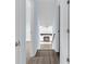 Hallway with view of fireplace featuring white painted brick and dark wood mantle at 1139 Mainstreet Valley Dr, Stone Mountain, GA 30088