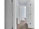 Hallway features light blue walls and gray wood-look floors with several white doors at 1139 Mainstreet Valley Dr, Stone Mountain, GA 30088