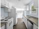 Updated kitchen with white cabinets, neutral countertops, and stainless steel appliances at 1139 Mainstreet Valley Dr, Stone Mountain, GA 30088