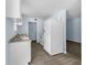 Efficient kitchen with white appliances, granite countertops, and modern gray wood-look floors at 1139 Mainstreet Valley Dr, Stone Mountain, GA 30088
