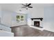 Charming living room with a white stone fireplace and mantel, complemented by gray wood-look flooring at 1139 Mainstreet Valley Dr, Stone Mountain, GA 30088