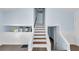 Inviting staircase with wood treads, light blue walls, and stylish white trim at 1139 Mainstreet Valley Dr, Stone Mountain, GA 30088