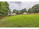 Lush backyard with a wooden fence surrounding the perimeter of the property at 275 Mountain Way, Covington, GA 30016