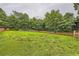 Expansive backyard surrounded by mature trees and a wooden fence at 275 Mountain Way, Covington, GA 30016