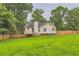 View of the backyard with wood fencing and treed perimeter at 275 Mountain Way, Covington, GA 30016
