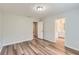 Spacious bedroom with hardwood floors, neutral paint, and two doorways offering easy access to other areas at 275 Mountain Way, Covington, GA 30016