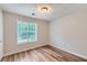 Bright bedroom features wood-look floors and a large window at 275 Mountain Way, Covington, GA 30016