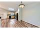 An open dining area features modern lighting, seamlessly connecting the space to a well-lit kitchen with stainless steel appliances at 275 Mountain Way, Covington, GA 30016