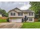 Charming two-story home featuring neutral siding, black shutters, and an attached two car garage at 275 Mountain Way, Covington, GA 30016