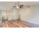 Open-concept living area with wood-look floors and modern lighting, connecting to upper level at 275 Mountain Way, Covington, GA 30016