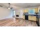 Open concept living space with fireplace, with updated flooring, and an adjacent kitchen area at 275 Mountain Way, Covington, GA 30016