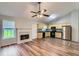 Open concept living space with fireplace, with updated flooring, and an adjacent kitchen area at 275 Mountain Way, Covington, GA 30016