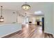 Open concept living space featuring vaulted ceilings, updated flooring, and an adjacent kitchen area at 275 Mountain Way, Covington, GA 30016