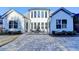 Exterior view of the home featuring a paved patio with outdoor seating and well-manicured landscaping at 3355 Olivia Ct, Cumming, GA 30041