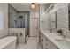 Modern bathroom with glass shower, soaker tub, double sinks, and white subway tile at 3355 Olivia Ct, Cumming, GA 30041