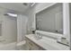 Bright bathroom with a large, illuminated mirror, modern vanity, and shower-tub combination at 3355 Olivia Ct, Cumming, GA 30041