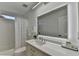 Modern bathroom featuring a vanity with an illuminated mirror, a toilet, and a shower-tub combination at 3355 Olivia Ct, Cumming, GA 30041