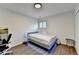 Bright bedroom featuring wood floors, a bed with LED lights, and a window with white shutters at 3355 Olivia Ct, Cumming, GA 30041