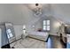 Spacious attic bedroom with stylish cube lighting, a minimalist design, and hardwood floors at 3355 Olivia Ct, Cumming, GA 30041