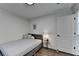 Cozy bedroom featuring a gray bed frame, a small table, and white walls at 3355 Olivia Ct, Cumming, GA 30041