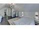 Attic bedroom with slanted ceilings, hardwood floors, modern lighting, and minimalist furniture at 3355 Olivia Ct, Cumming, GA 30041